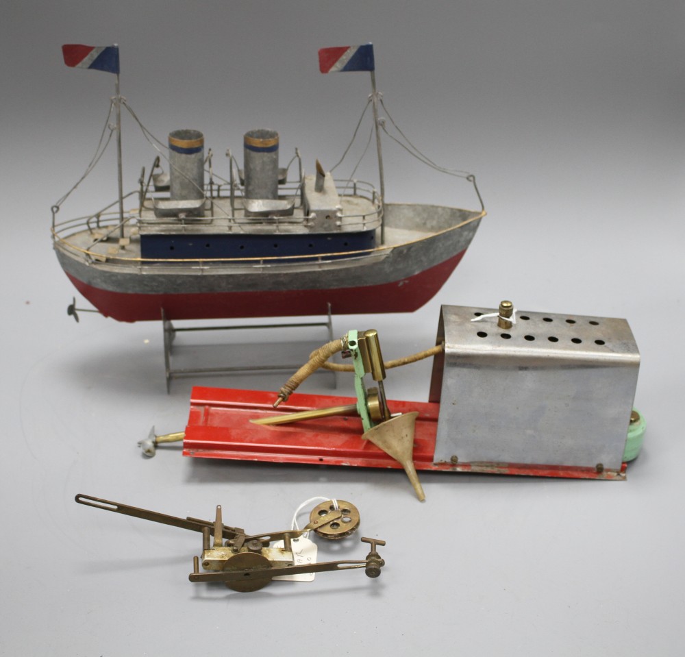 A 1950s Mamod ME1 clockwork steam engine, a Vane gear for a pond yacht and a modern painted metal model of a boat